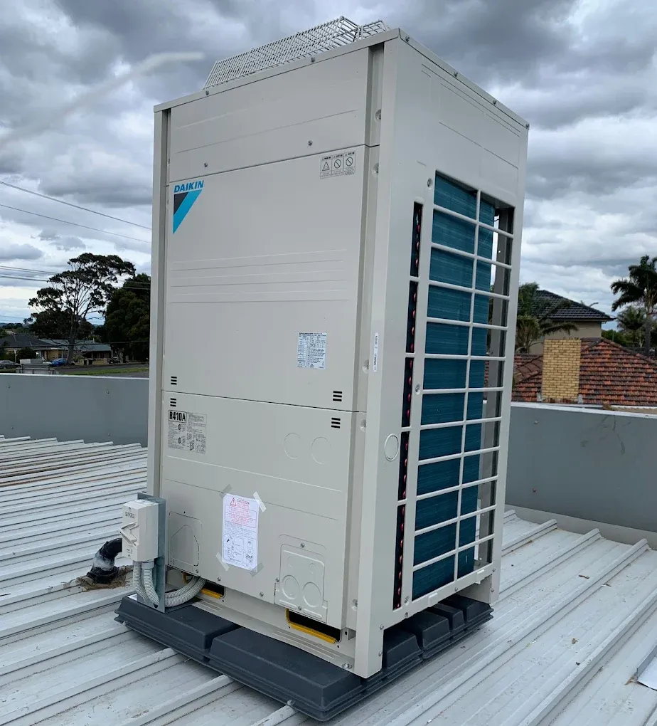 Large Daikin ducted outdoor unit installed on a metal roof