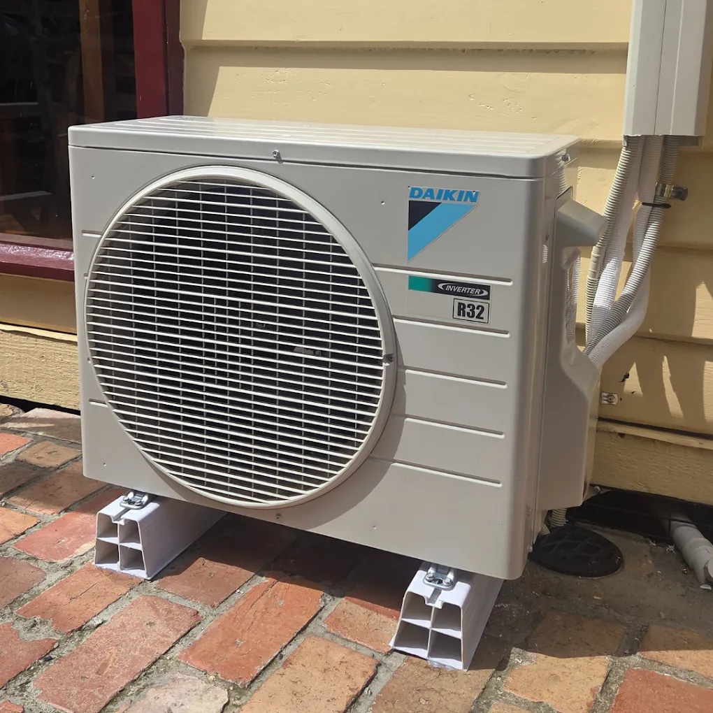 Daikin split system outdoor unit mounted on floor supports